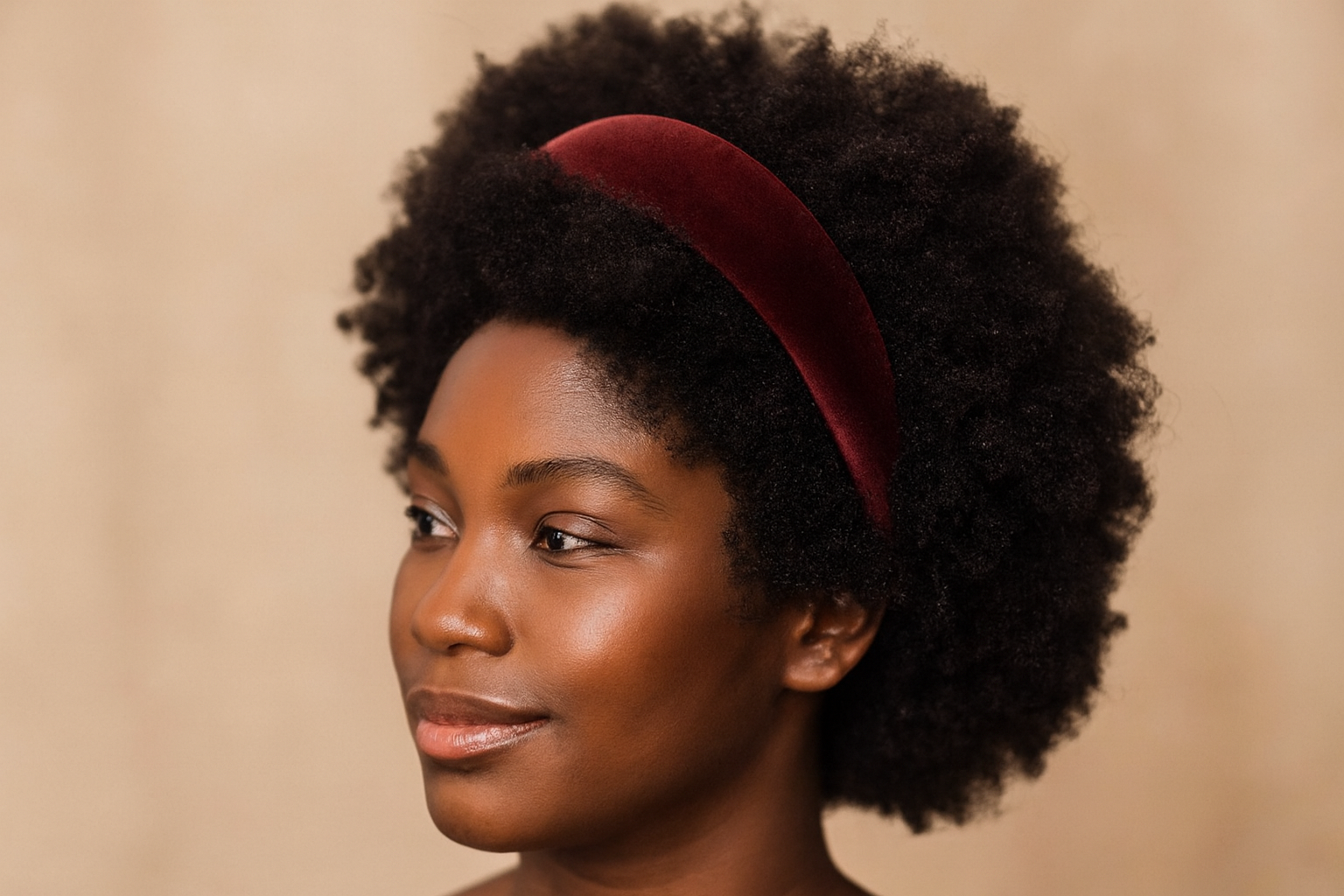 Model with coily hair wearing headband